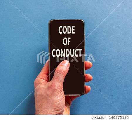 Code of conduct words symbol. Concept words Code of conduct on beautiful black mobile phone screen. Beautiful blue background. Businessman hand. Business Code of conduct concept. Copy space. Code of conduct words symbol. Concept words Code of conduct on beautiful black mobile phone screen. Beautiful blue background. Businessman hand. Business Code of conduct concept. Copy space. 140575186