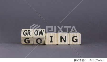 Going and growing symbol. Concept words Going Growing on beautiful wooden blocks. Beautiful grey background. Business going and growing concept. Copy space. 140575225