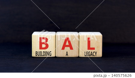 BAL building a legacy symbol. Concept words BAL building a legacy on beautiful wooden blocks. Beautiful black background. Business BAL building a legacy concept. Copy space. BAL building a legacy symbol. Concept words BAL building a legacy on beautiful wooden blocks. Beautiful black background. Business BAL building a legacy concept. Copy space. 140575626