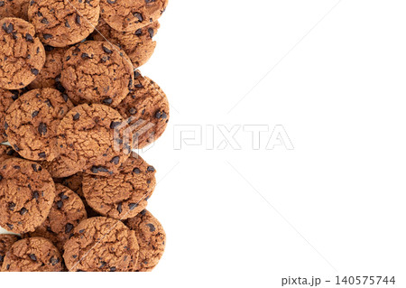 Heap of Chocolate Chip Cookies at the Bottom on White Background with Large Copy Space for Bakery Advertising Heap of Chocolate Chip Cookies at the Bottom on White Background with Large Copy Space for Bakery Advertising 140575744