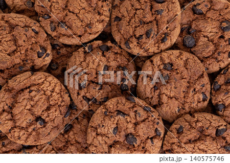 Close-Up Top View of Chocolate Chip Cookies Spilling from Small Yellow Shopping Cart Isolated on White Background Close-Up Top View of Chocolate Chip Cookies Spilling from Small Yellow Shopping Cart Isolated on White Background 140575746