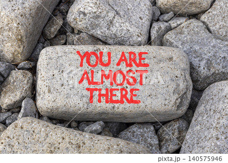 You are almost there symbol. Concept words You are almost there on beautiful grey stone. Beautiful grey stones background. Business You are almost there motivational support concept. Copy space 140575946