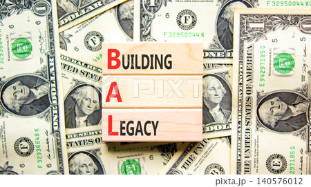 BAL building a legacy symbol. Concept words BAL building a legacy on beautiful wooden blocks. Beautiful dollar bills background. Dollar bills. Business BAL building a legacy concept. Copy space. 140576012
