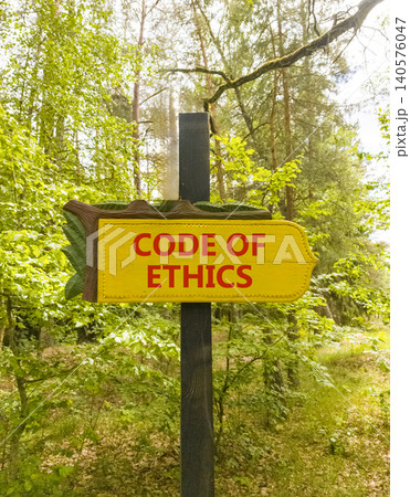Code of ethics words symbol. Concept words Code of ethics on beautiful yellow road sign. Beautiful green forest background. Business Code of ethics concept. Copy space. Code of ethics words symbol. Concept words Code of ethics on beautiful yellow road sign. Beautiful green forest background. Business Code of ethics concept. Copy space. 140576047