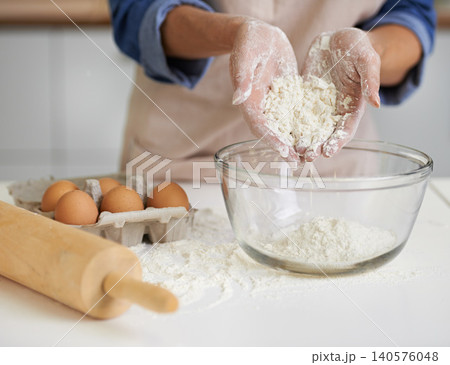 Hands, person and flour with eggs, kitchen and rolling pin for baking. Baker, dough and food with countertop, apron and mixing for recipe preparation and recreation or hobby at home or house Hands, person and flour with eggs, kitchen and rolling pin for baking. Baker, dough and food with countertop, apron and mixing for recipe preparation and recreation or hobby at home or house 140576048