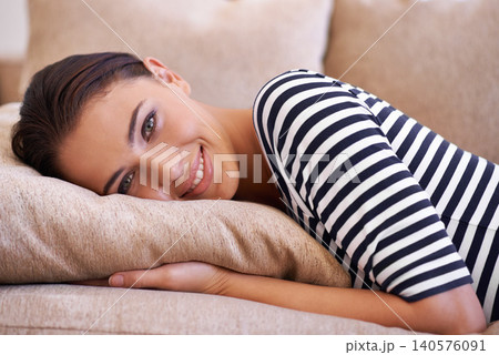 Woman, portrait and happy to relax on couch, chill and smile while lazy or comfortable in home. Female person, afternoon and resting on sofa in living room, peace and mindfulness or calm confidence Woman, portrait and happy to relax on couch, chill and smile while lazy or comfortable in home. Female person, afternoon and resting on sofa in living room, peace and mindfulness or calm confidence 140576091