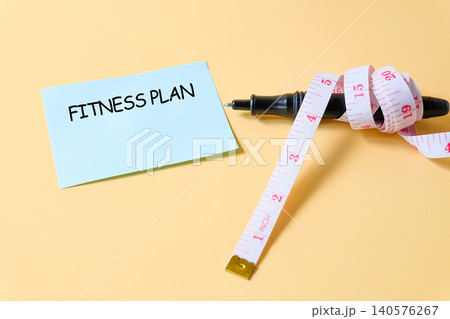 Wrap the measuring tape around the pen with paper note. 140576267