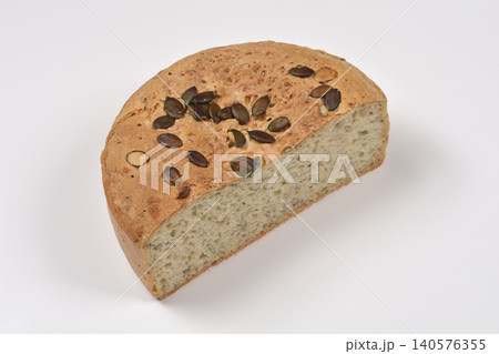 Half of Round Bread Loaf with Pumpkin Seeds on White Background Half of Round Bread Loaf with Pumpkin Seeds on White Background 140576355