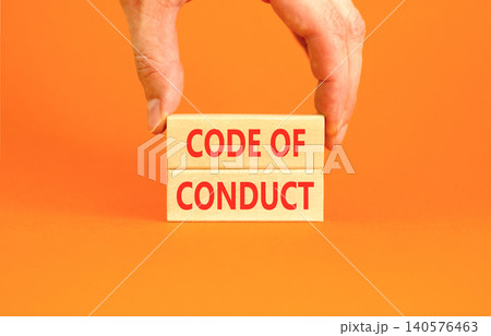 Code of conduct words symbol. Concept words Code of conduct on beautiful wooden blocks. Beautiful orange background. Businessman hand. Business Code of conduct concept. Copy space. Code of conduct words symbol. Concept words Code of conduct on beautiful wooden blocks. Beautiful orange background. Businessman hand. Business Code of conduct concept. Copy space. 140576463