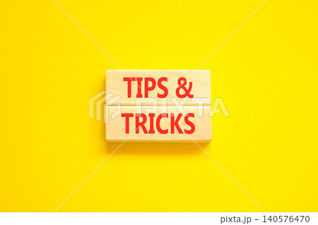 Tips and tricks words symbol. Concept words Tips and tricks on beautiful wooden blocks. Beautiful yellow background. Business tips and tricks motivational support concept. Copy space. Tips and tricks words symbol. Concept words Tips and tricks on beautiful wooden blocks. Beautiful yellow background. Business tips and tricks motivational support concept. Copy space. 140576470