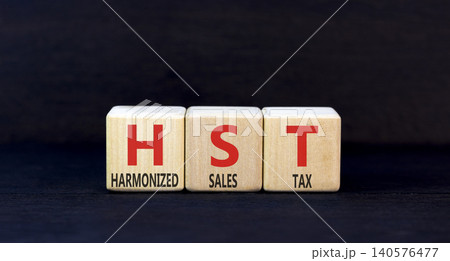 HST harmonized sales tax symbol. Concept words HST harmonized sales tax on beautiful wooden blocks. Beautiful black background. Business HST harmonized sales tax concept. Copy space HST harmonized sales tax symbol. Concept words HST harmonized sales tax on beautiful wooden blocks. Beautiful black background. Business HST harmonized sales tax concept. Copy space 140576477