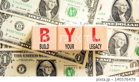 BYL build your legacy symbol. Concept words BYL build your legacy on beautiful wooden blocks. Beautiful dollar bills background. Business BYL build your legacy concept. Copy space 140576479