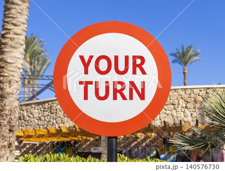 Your turn words symbol. Concept words Your turn on beautiful white road sign. Beautiful blue sky green field background. Business your turn motivational support concept. Copy space. 140576730