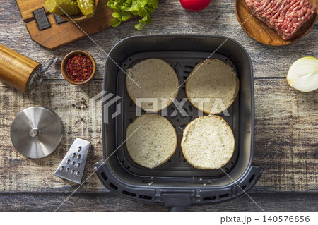 Step 1. Cooking homemade cheeseburger in kitchen gadget modern air fryer. Lifestyle trendy of new cooking. Step 1. Cooking homemade cheeseburger in kitchen gadget modern air fryer. Lifestyle trendy of new cooking. 140576856