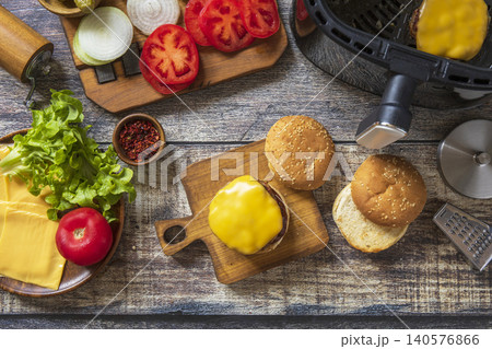 Step 11. Cooking homemade cheeseburger in kitchen gadget modern air fryer. Lifestyle trendy of new cooking. Step 11. Cooking homemade cheeseburger in kitchen gadget modern air fryer. Lifestyle trendy of new cooking. 140576866