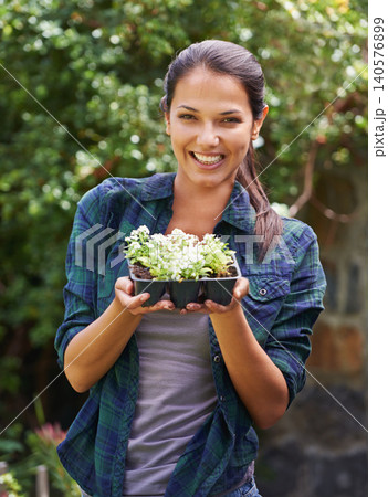 Woman, smile and seedling for gardening and plant in environment outdoor with tree and sunshine. Gardener and happy person with shrub in soil for sustainability, growth and earth for lawn or garden Woman, smile and seedling for gardening and plant in environment outdoor with tree and sunshine. Gardener and happy person with shrub in soil for sustainability, growth and earth for lawn or garden 140576899