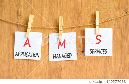 AMS application managed services symbol. Concept words AMS application managed services on beautiful white papers on wooden clothespins. Beautiful wooden background. Business AMS concept. Copy space. AMS application managed services symbol. Concept words AMS application managed services on beautiful white papers on wooden clothespins. Beautiful wooden background. Business AMS concept. Copy space. 140577088