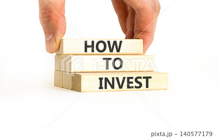 How to invest words symbol. Concept words How to invest on beautiful wooden blocks. Beautiful white background. Businessman hand. Business and how to invest concept. Copy space. How to invest words symbol. Concept words How to invest on beautiful wooden blocks. Beautiful white background. Businessman hand. Business and how to invest concept. Copy space. 140577179