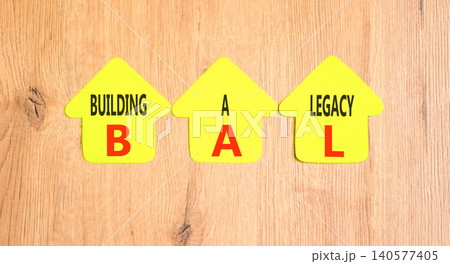 BAL building a legacy symbol. Concept words BAL building a legacy on beautiful yellow paper houses. Beautiful wooden background. Business BAL building a legacy concept. Copy space. BAL building a legacy symbol. Concept words BAL building a legacy on beautiful yellow paper houses. Beautiful wooden background. Business BAL building a legacy concept. Copy space. 140577405