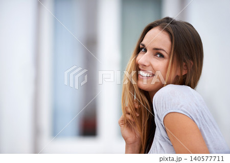 Portrait, fashion and happy woman with smile, outside and playful and relax. Confidence, stylish or hand with hair for Canadian female person, casual or contemporary outfit for travel or vacation 140577711
