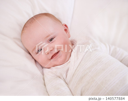Baby, portrait and smile on bed for relax comfort in family home for childhood development for growth, morning or care. Kid, boy and face on linen bedding in apartment with happiness, love or calm Baby, portrait and smile on bed for relax comfort in family home for childhood development for growth, morning or care. Kid, boy and face on linen bedding in apartment with happiness, love or calm 140577884