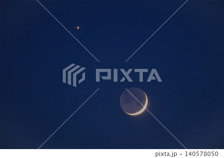Crescent moon and bright venus planet in the dark blue night sky Crescent moon and bright venus planet in the dark blue night sky 140578050