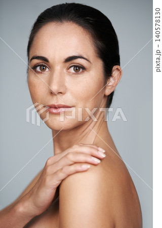 Woman, studio and portrait with beauty, skin and care for treatment and proud. Model, cosmetics and natural with lip gloss, glow and aesthetic for antiaging confidence isolated on grey background Woman, studio and portrait with beauty, skin and care for treatment and proud. Model, cosmetics and natural with lip gloss, glow and aesthetic for antiaging confidence isolated on grey background 140578130