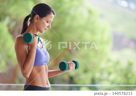 Woman, weightlifting and exercise with dumbbells for muscle gain, workout or outdoor training on balcony. Young female person with small barbells for sport, fitness or health and wellness in nature Woman, weightlifting and exercise with dumbbells for muscle gain, workout or outdoor training on balcony. Young female person with small barbells for sport, fitness or health and wellness in nature 140578215