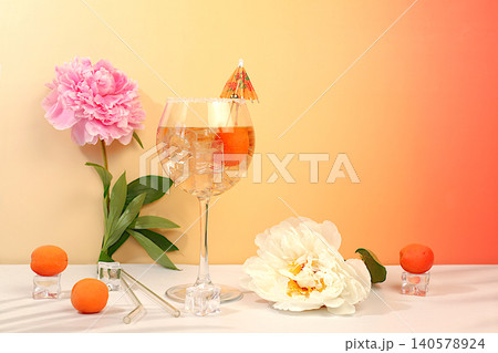 Royal lemonade cocktail with tequila, gin, rum, ice and fresh apricot berries, bar and party concept with peonies, restaurant and cafe advertising card, minimal still life with flowers and alcohol, Royal lemonade cocktail with tequila, gin, rum, ice and fresh apricot berries, bar and party concept with peonies, restaurant and cafe advertising card, minimal still life with flowers and alcohol, 140578924