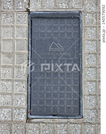 Cordoba, Argentina - April 7, 2026: Aguas Cordobesas utility manhole cover embedded in a city sidewalk in Cordoba, Argentina 140579092