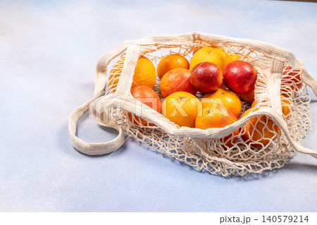Citrus fruits and blood oranges in reusable net bag 140579214