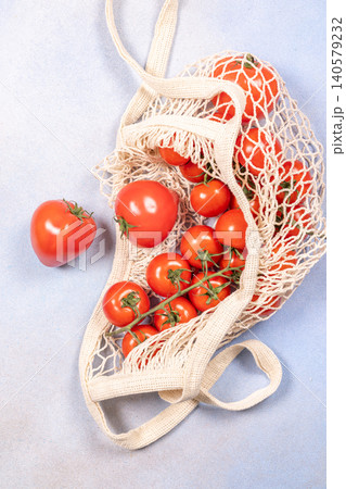 Fresh organic tomatoes in reusable mesh net bag Fresh organic tomatoes in reusable mesh net bag 140579232