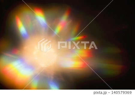 Abstract light pattern with vibrant rainbow colors radiating from a central bright source against a dark background, creating a visually striking effect Abstract light pattern with vibrant rainbow colors radiating from a central bright source against a dark background, creating a visually striking effect 140579369