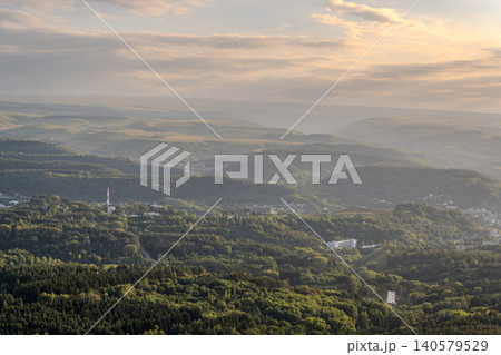 Layers of green mountains and hills in the haze during sunset. Panoramic View of Green hills and Meadow. 140579529