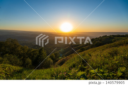 View of the mountains and Kislovodsk from the observation decks of the Kislovodsk Park. Evening sunset over the mountains of Kislovodsk. 140579905