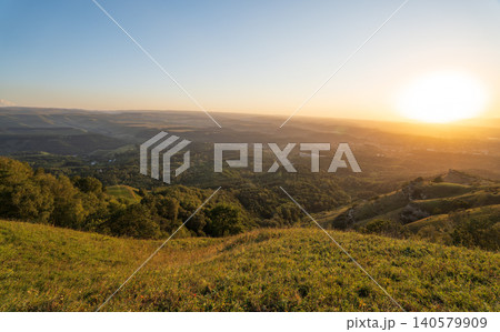 View of the mountains and Kislovodsk from the observation decks of the Kislovodsk Park. Evening sunset over the mountains of Kislovodsk. View of the mountains and Kislovodsk from the observation decks of the Kislovodsk Park. Evening sunset over the mountains of Kislovodsk. 140579909