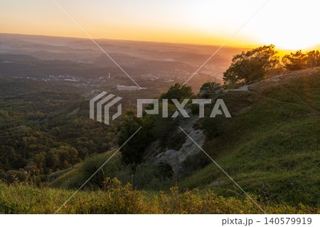 View of the mountains and Kislovodsk from the observation decks of the Kislovodsk Park. Evening sunset over the mountains of Kislovodsk. 140579919