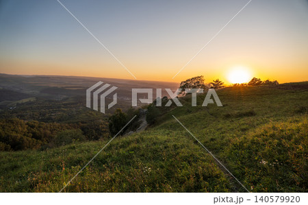 View of the mountains and Kislovodsk from the observation decks of the Kislovodsk Park. Evening sunset over the mountains of Kislovodsk. View of the mountains and Kislovodsk from the observation decks of the Kislovodsk Park. Evening sunset over the mountains of Kislovodsk. 140579920