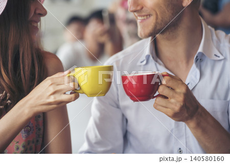 Young couple talking in cafe coffee shop happy date couple communication positive relationship while relaxing in cafe drinking coffee and talkative. Valentine's day concept. Young couple talking in cafe coffee shop happy date couple communication positive relationship while relaxing in cafe drinking coffee and talkative. Valentine's day concept. 140580160