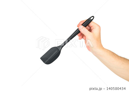 hand holding a black pastry spatula at an angle towards the right on a white background hand holding a black pastry spatula at an angle towards the right on a white background 140580434