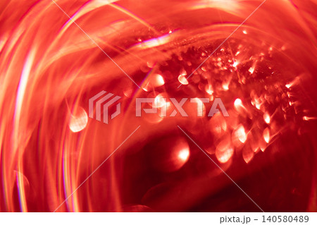 Abstract red light patterns with blurred reflections and circular shapes creating a vibrant and dynamic visual effect in a dark background setting Abstract red light patterns with blurred reflections and circular shapes creating a vibrant and dynamic visual effect in a dark background setting 140580489