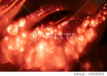Abstract close-up image of shimmering red and orange bokeh lights with soft focus, creating a vibrant and dynamic visual effect in a dark background setting Abstract close-up image of shimmering red and orange bokeh lights with soft focus, creating a vibrant and dynamic visual effect in a dark background setting 140580501