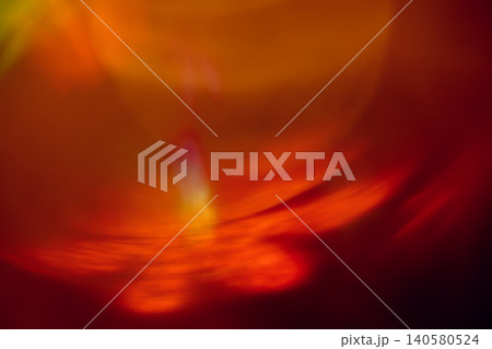 Abstract colorful light patterns with warm hues of red, orange, and yellow creating a vibrant and dynamic visual effect on a blurred background 140580524