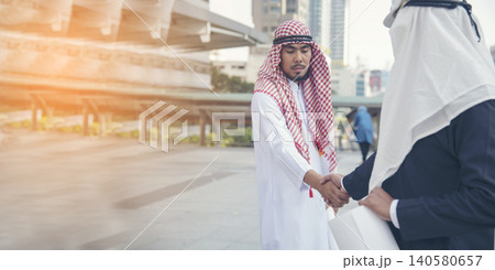 Banner Arab Businessman Muslim dress shaking hands together. Panorama Muslim Men Teamwork business partner handshake teams Partnership. multiracial UAE diversity people trust honesty with copy space Banner Arab Businessman Muslim dress shaking hands together. Panorama Muslim Men Teamwork business partner handshake teams Partnership. multiracial UAE diversity people trust honesty with copy space 140580657