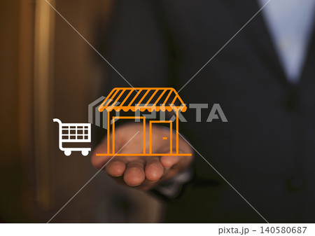 Businessman holding digital shopping cart and store icon in hand, representing e-commerce and online shopping concepts in a modern business environment Businessman holding digital shopping cart and store icon in hand, representing e-commerce and online shopping concepts in a modern business environment 140580687