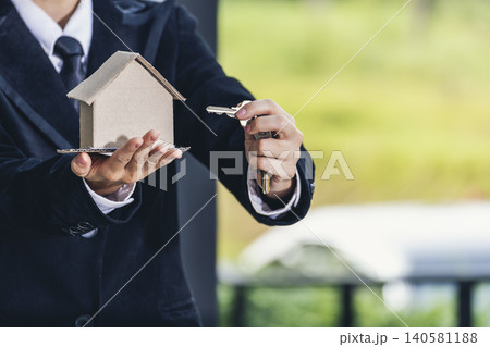 Real estate agent hands holding home business mortgage loan investment property. Hands saving protection home residential concepts. Insurance Agent sale residence ownership household protection care Real estate agent hands holding home business mortgage loan investment property. Hands saving protection home residential concepts. Insurance Agent sale residence ownership household protection care 140581188