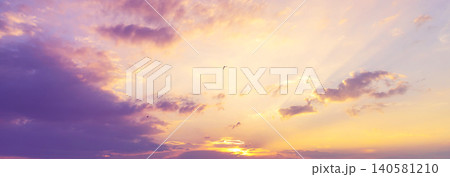 Banner purple sky sunrise dramatic beautiful landscape view. Dawn sky violet pink gold dusk time cloudscape with sunlight. Panorama Dramatic vibrant sunset scenic landscape nature with copy space Banner purple sky sunrise dramatic beautiful landscape view. Dawn sky violet pink gold dusk time cloudscape with sunlight. Panorama Dramatic vibrant sunset scenic landscape nature with copy space 140581210