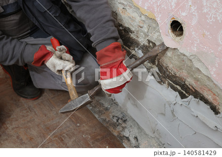 Adult worker demolish old house Adult worker demolish old house 140581429