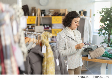 Woman choosing a knitted hat 140582029