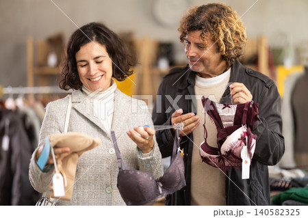 Married couple woman and man search and choose bra Married couple woman and man search and choose bra 140582325